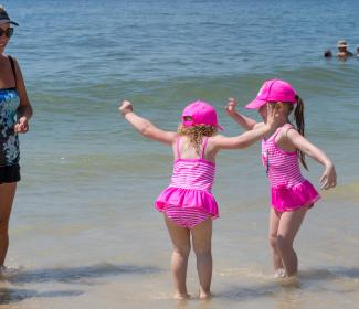 little girls playing on the beach