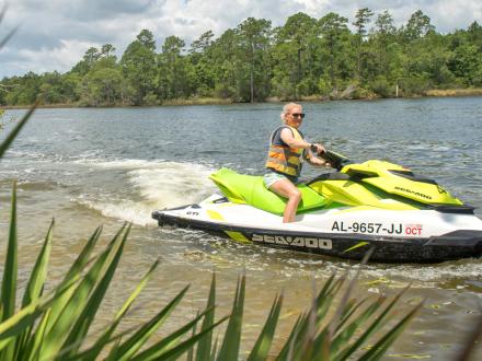 Women riding a Jet Ski on the backbays in Orange Beach