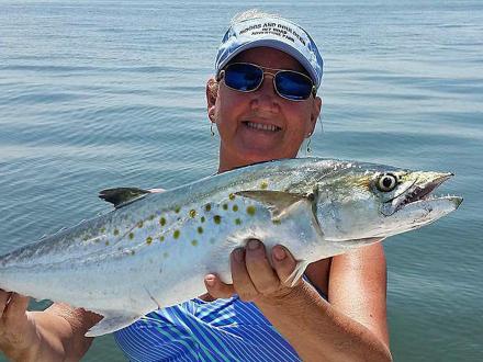 Woman holding a Spanish mackerel