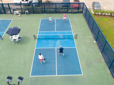 People playing pickleball at One Club's pickleball courts