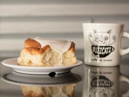 Fresh cinnamon roll and coffee at Buzzcatz Coffee & Sweets in Orange Beach