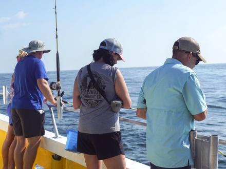 People fishing in the Gulf on an offshore fishing charter