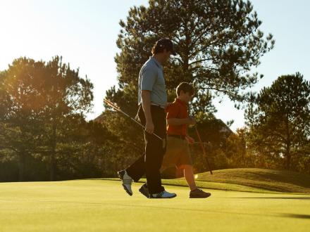 Father and son golfing in Gulf Shores