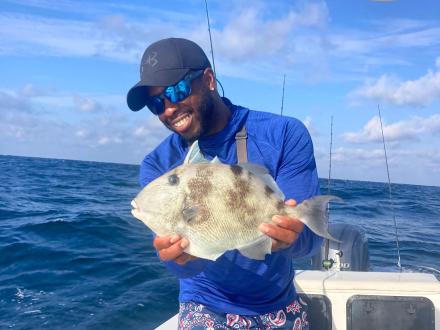 Man holding trigger on a charter boat in Orange Beach
