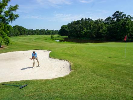 Man playing golf at Craft Farms Resort, top golf course in Alabama