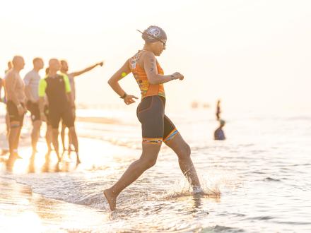 Woman triathlon runner preparing to start the swim portion