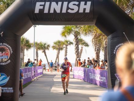 Woman crossing the finish line in a triathlon