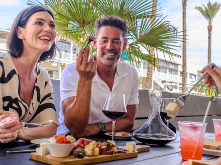 Couple dining outside at Villaggio Grille Italian restaurant in Orange Beach