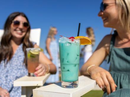 Friends enjoying drinks at Zeke's waterfront restaurant in Orange Beach