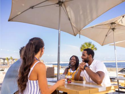 People dining outdoors at The Gulf beachfront restaurant in Orange Beach