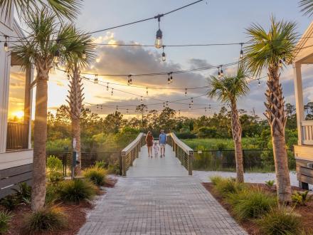 Family walking on a boardwalk at Beach Village Resort