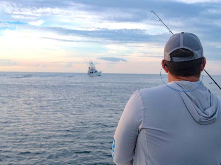 Man watching the sunset from a fishing charter boat in Orange Beach