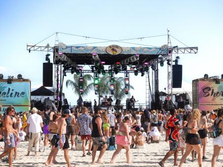 Crowd in front of a stage set up on the beach at Sand in My Boots Festival in Gulf Shores