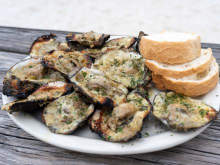 A plate of a dozen chargrilled oysters at Flora-Bama
