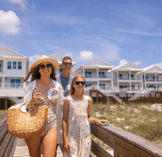 Family walking down boardwalk to the beach