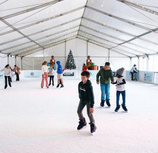Kids ice skating at the ice skating rink at The Wharf in Orange Beach